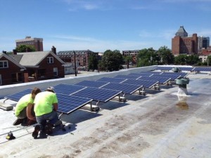 Workers install solar panels at Faith Community Church in Greensboro. Photo provided by NC WARN