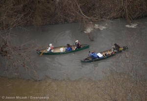 People in canoes maneuver in the Dan River where a coal ash spill discolored the river in Eden.  Duke Energy said that 50,000 to 82,000 tons of coal ash and up to 27 million gallons of water were released through a broken stormwater pipe from a 27-acre unlined pond at the Dan River Steam Station which closed in 2012.